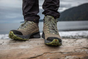 a close up of a pair of hiking boots on a log (1)
